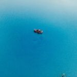 a small boat floating on top of a large body of water